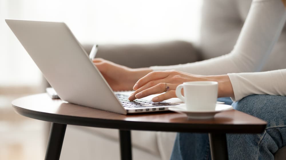 Person Typing on Laptop at Desk While Blogging — Metwide Communications in Gold Coast, QLD