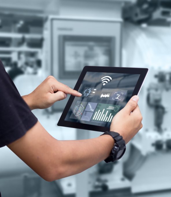 Smart Industry Control Using Tablet With Automated Machinery in Background — Metwide Communications in Brisbane, QLD