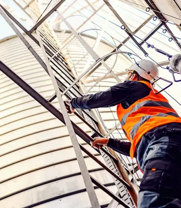 Lone Worker Climbing Up Water Tanks for Inspection — Metwide Communications in Gold Coast, QLD